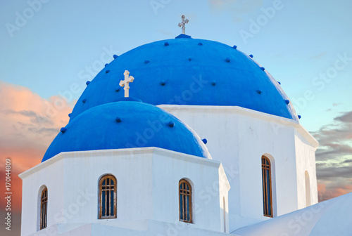 Classic view of blue dome church in Santorini.