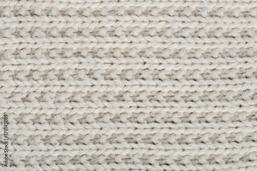 Photos The texture of a thick knitted sweater beige close-up