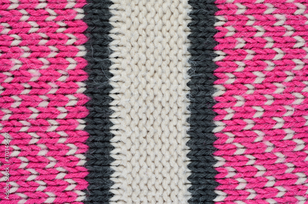 Texture of a beige knitted sweater close-up. Three-color pattern knitted winter sweater Texture of a beige knitted sweater close-up. Three-color pattern knitted winter sweater