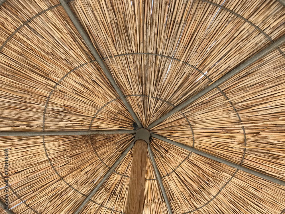 Straw umbrellas on a beach. Suitable to be used like a background.