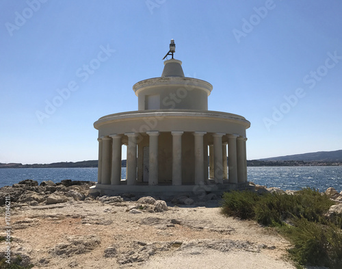 The lighthouse of Saint Theodoroi: a white marble temple on a cliff in Cephalonia or Kefalonia in Greece.