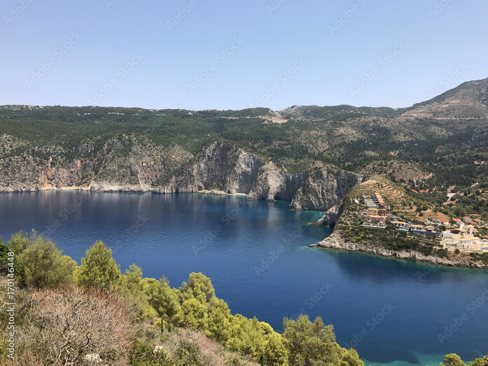 The high grey cliff on turquoise and blue sea near Assos in Cephalonia or Kefalonia, Greece