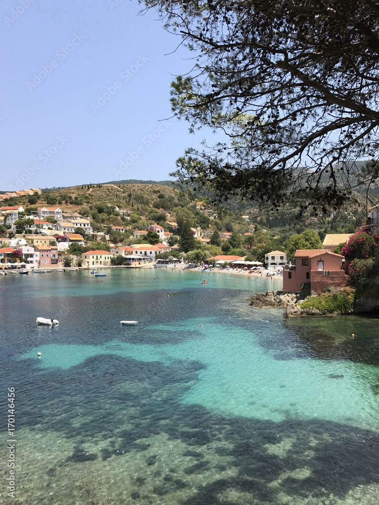 The Assos village with its turquoise bay and colorful buildings in Cephalonia or Kefalonia, Greece.