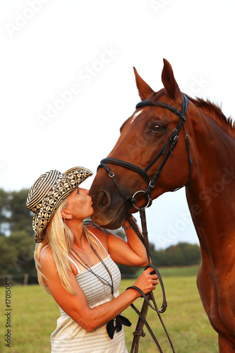 Portrait of woman and her horse on summer afternoon