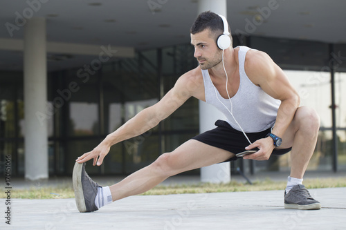 Male runner doing stretching exercise