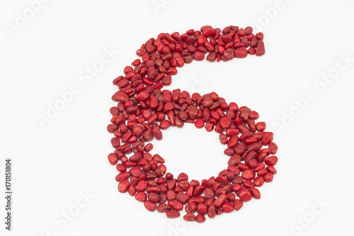 The number six, made by red stones.