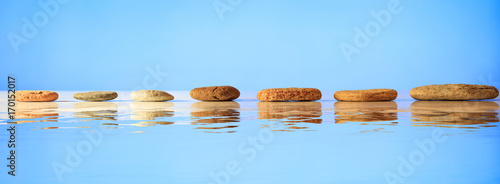 Canvas Print Zen stones row on blue background