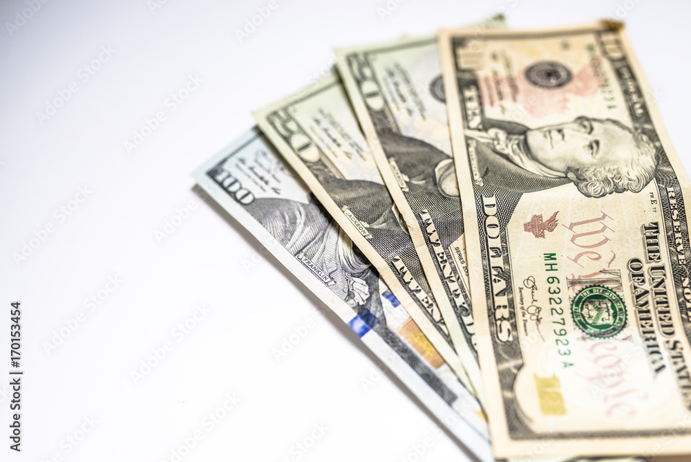 Pile of United States dollar hundred USD banknotes on white table. Selective focus Pile of United States dollar hundred USD banknotes on white table. Selective focus
