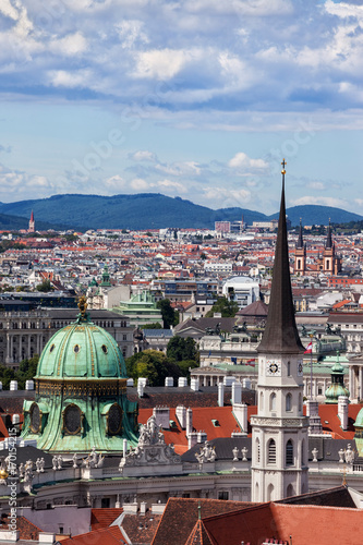 Austria, Vienna, capital city cityscape with dome of Hofburg Palace and tower of St. Michael's Church photo