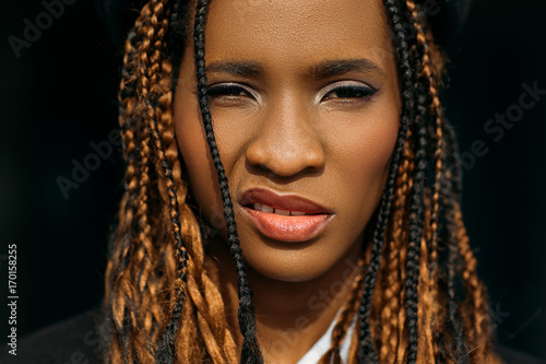 Impudent African American woman. Stylish hair. Insolent facial expression on black background, modern youth lifestyle, cocky concept