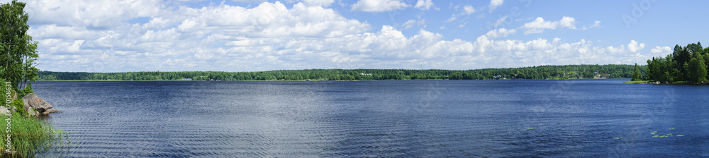 A natural landscape with a lake and clouds.