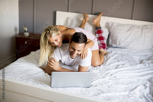 Intimate lovers using lapto...