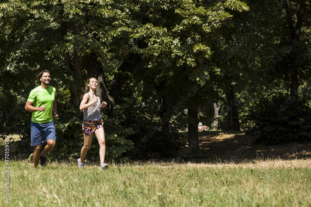 Young couple running in nature Young couple running in nature