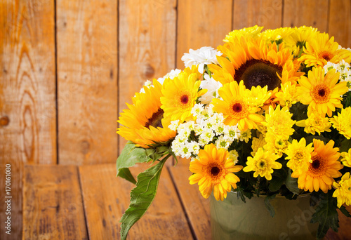 Fototapeta Naklejka Na Ścianę i Meble -  Autumn Flower Boquet with Sun Flowers on Wooden Background
