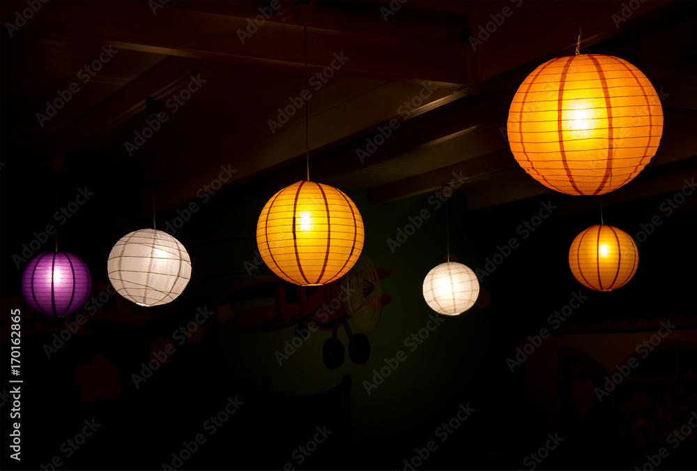 Obraz premium Colorful paper made lighting spheres on black background