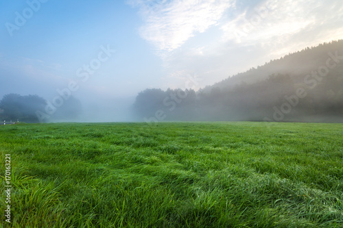 Blue sky with landscape in fog