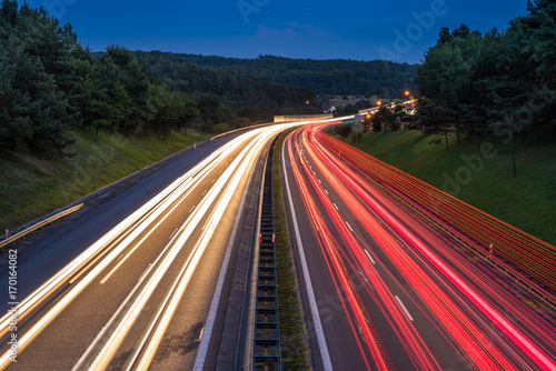 Speed traffic on highway at dusk. Colorful light trails on the street. Poland.