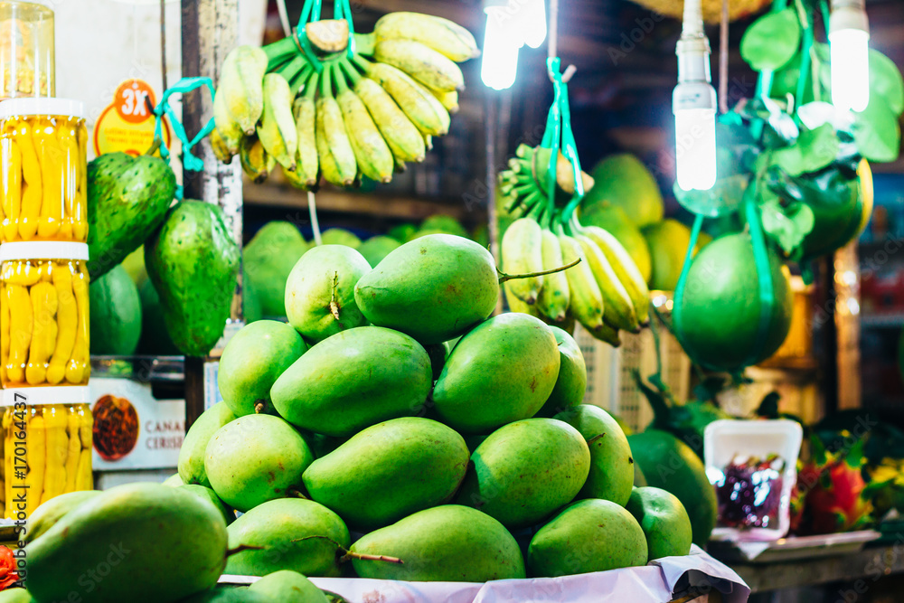 Mango and banana on a fresh fruit stall at the local market in Ho Chi