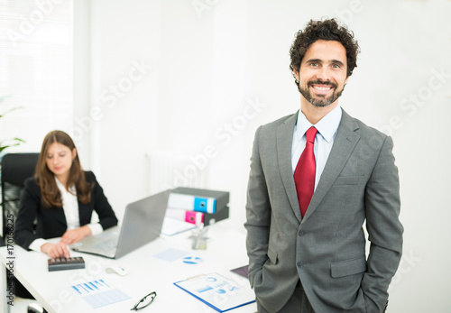 Smiling businessman in his office