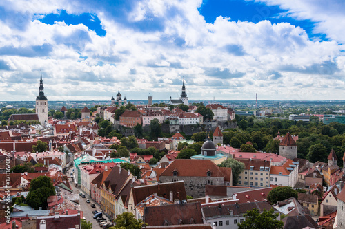 Fototapeta Naklejka Na Ścianę i Meble -  View of the old town of Tallinn from the observation deck. Red tiled roofs, the church of St. Olaf, the Baltic Sea in the background. Card. Estonia.