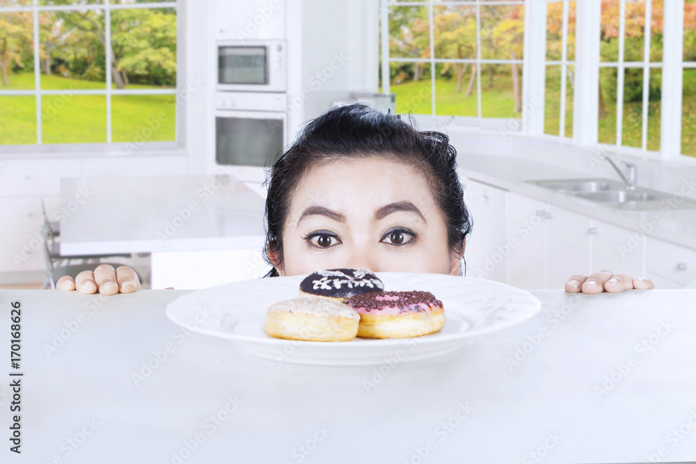 Woman and donuts in the kitchen
