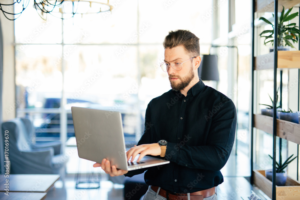 Young business man executive using laptop in office Young business man executive using laptop in office