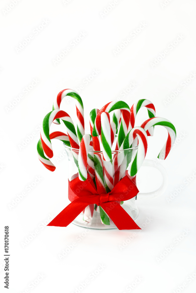 Fototapeta premium Candy Canes in a Glass on White Background