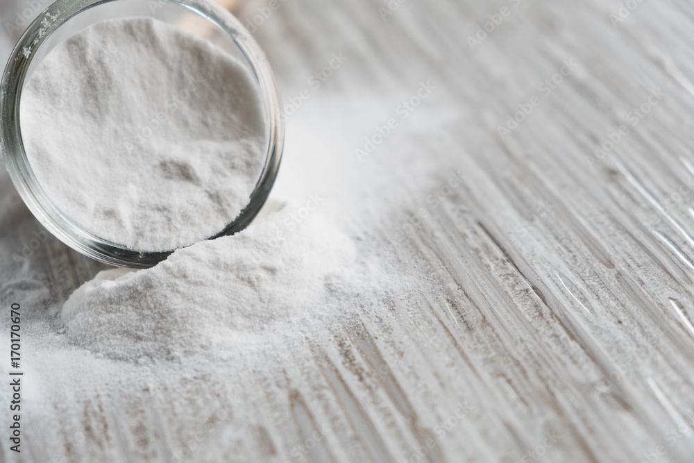 Glass bowl of baking soda. Spoonful of bicarbonate. Baking soda, Sodium bicarbonate, NaHCO3 Glass bowl of baking soda. Spoonful of bicarbonate. Baking soda, Sodium bicarbonate, NaHCO3