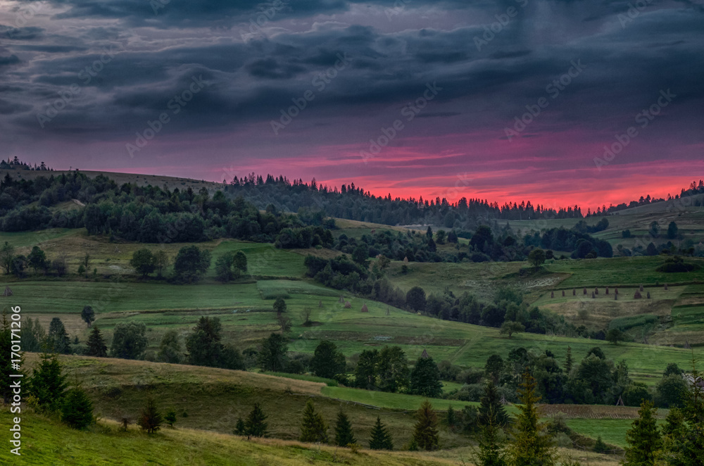 Fototapeta Background with Ukrainian Carpathian Mountains during the sunset in the Pylypets
