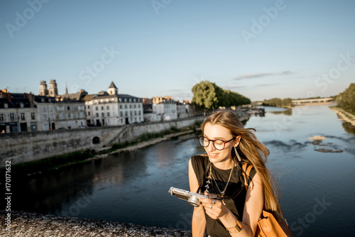 Young woman tourist standing on the bridge with beautiful cityscape view in Orleans, France © rh2010