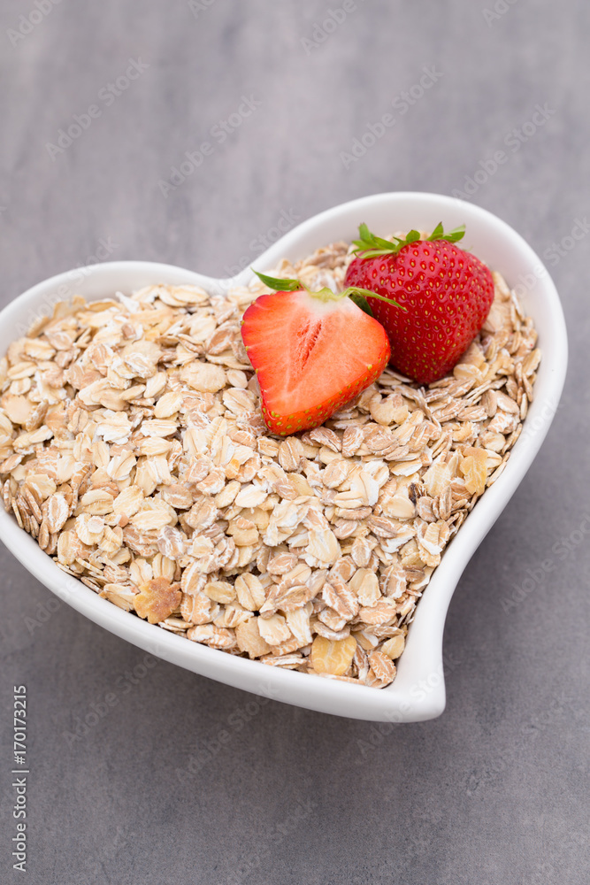 Dry rolled oatmeal in bowl. Dry rolled oatmeal in bowl.
