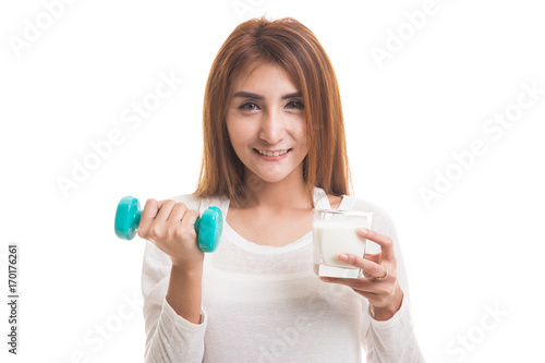 Healthy Asian woman drinking a glass of milk and dumbbell.