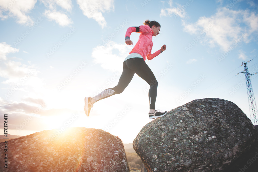 Athletic girl running in the mountains at sunset against the backdrop of a beautiful landscape. Sport tight clothes. Intentional motion blur. Athletic girl running in the mountains at sunset against the backdrop of a beautiful landscape. Sport tight clothes. Intentional motion blur.