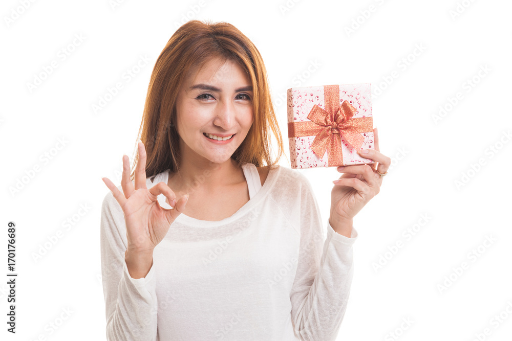 Young Asian woman show OK with a gift box. Young Asian woman show OK with a gift box.