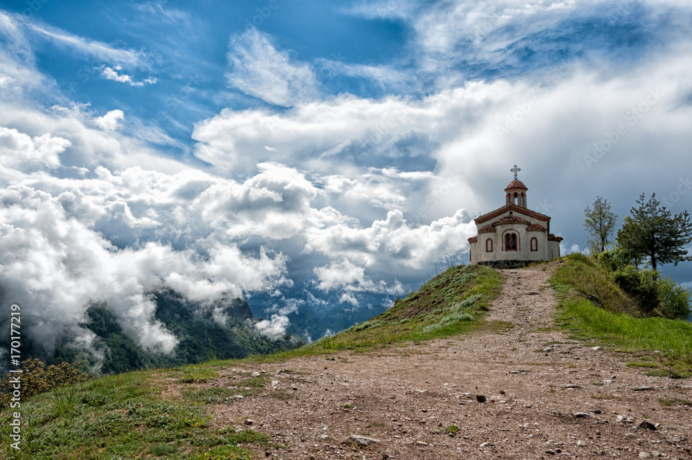 white clouds over a church in the mountains 2 white clouds over a church in the mountains 2
