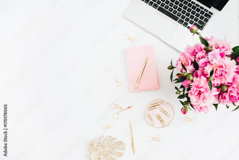 Flat lay home office desk. Woman workspace with laptop, pink peonies bouquet. Top view feminine background. Flat lay home office desk. Woman workspace with laptop, pink peonies bouquet. Top view feminine background.