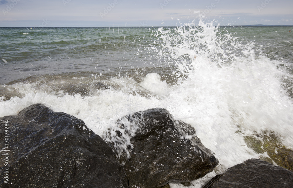 Waves hitting stones on the beach