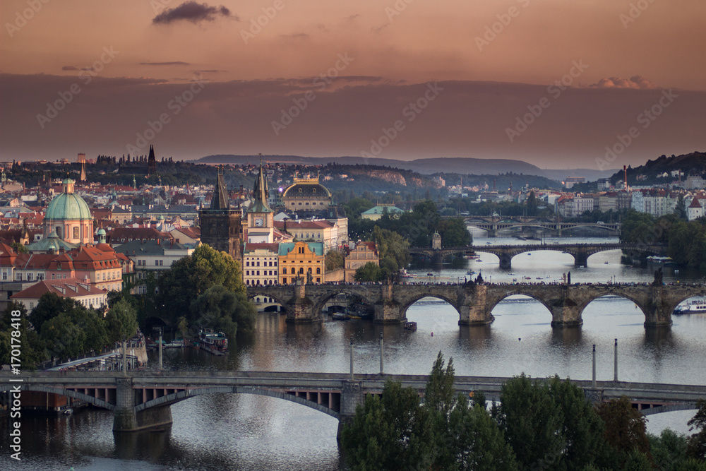 Obraz premium View of the Prague bridges with orange sky from above