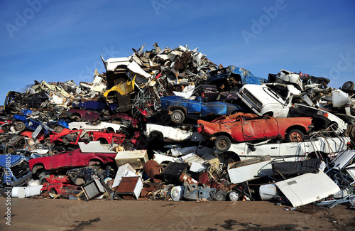 Фотография Old damaged cars on the junkyard waiting for recycling