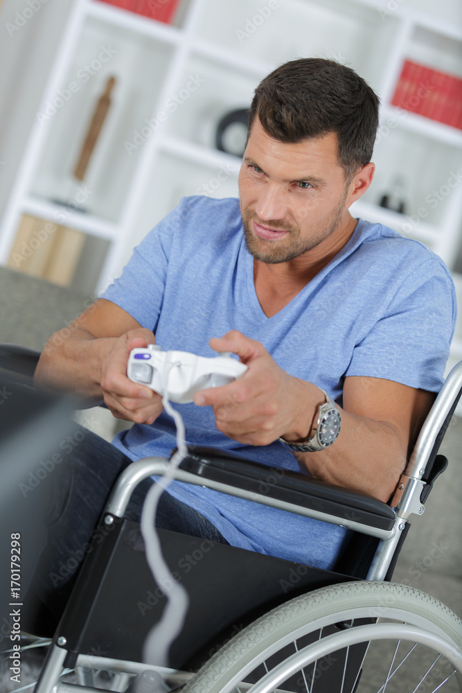 man in wheelchair plays video-games man in wheelchair plays video-games