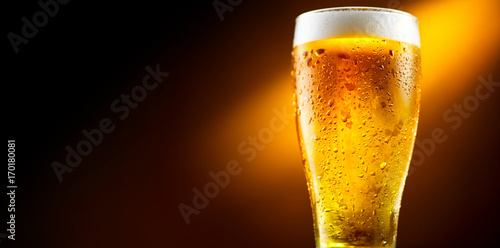 Beer. Glass of cold beer with water drops. Craft beer isolated on black background