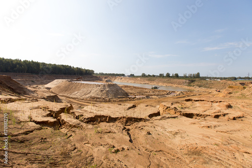 Mining in a sand quarry with powerful machines and a washing lake