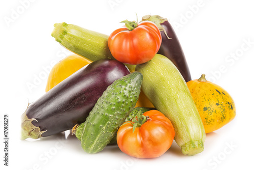 Vegetarian healthy food with vegetables. Tomatoes, cucumbers, bush pumpkins, eggplants and marrows isolated on white background.