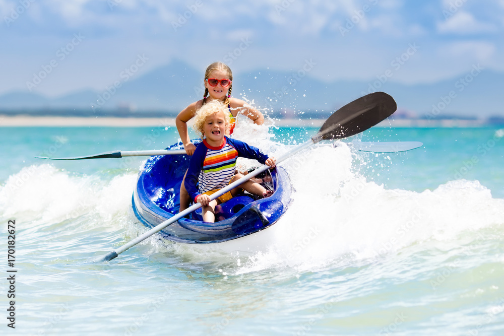 Kids kayaking in ocean. Children in kayak in tropical sea