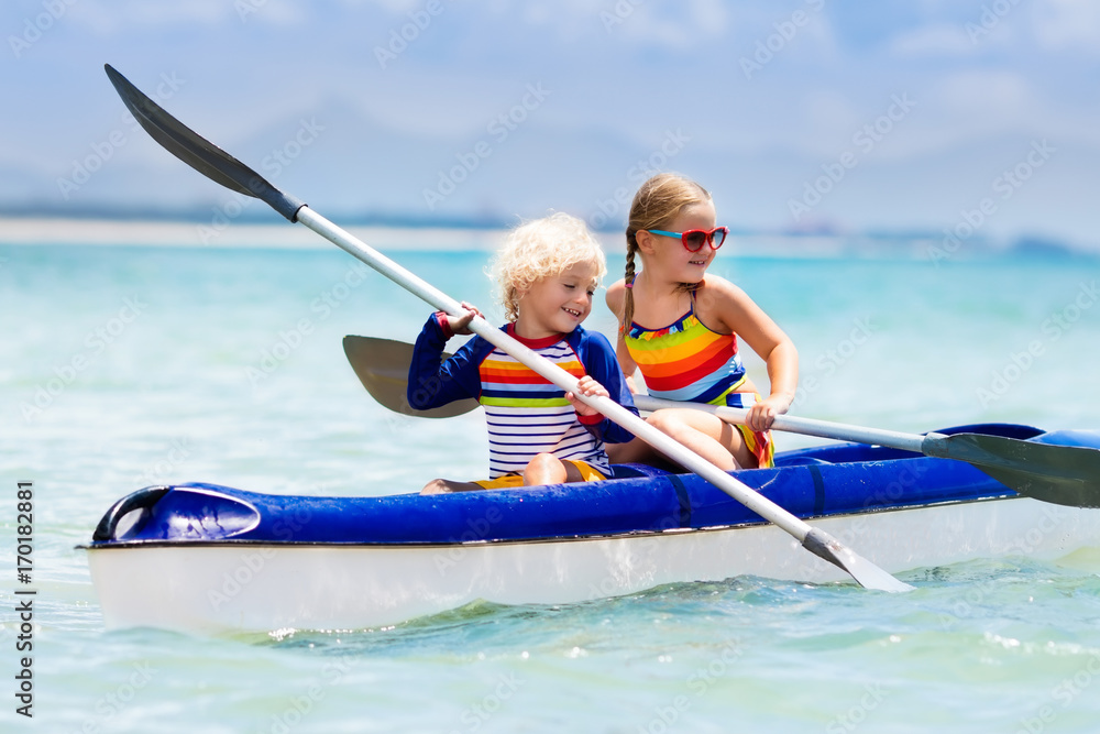 Obraz premium Kids kayaking in ocean. Children in kayak in tropical sea