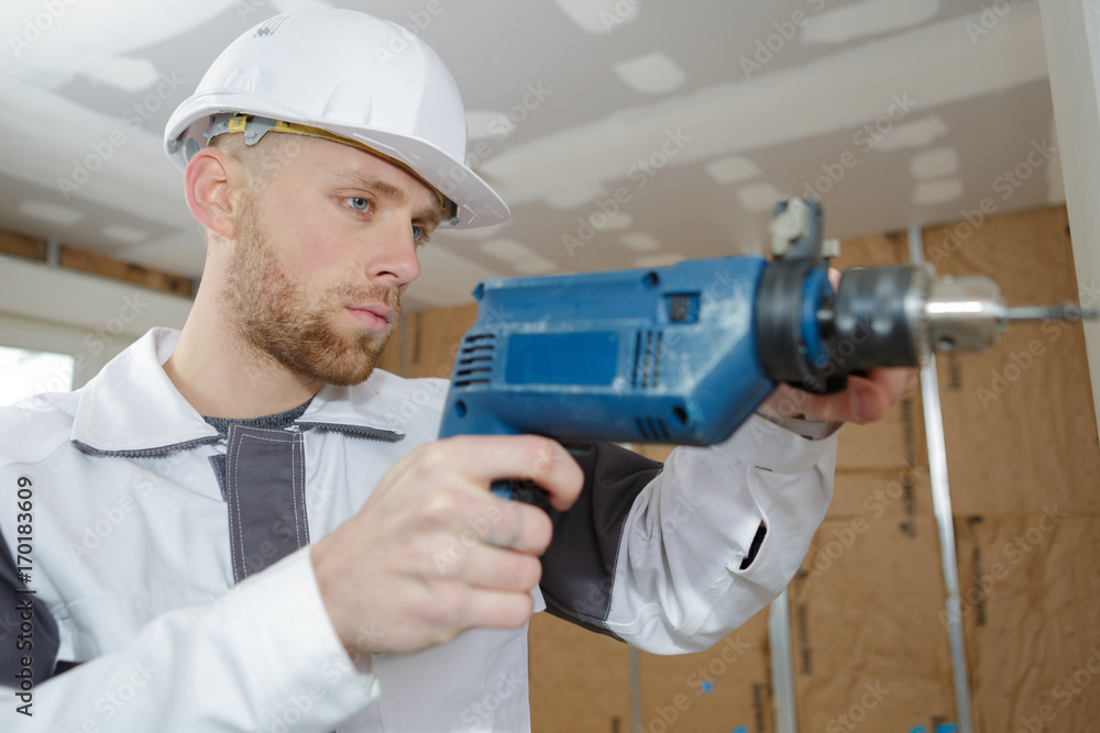 contractor uses hammer drill to drill the concrete wall contractor uses hammer drill to drill the concrete wall