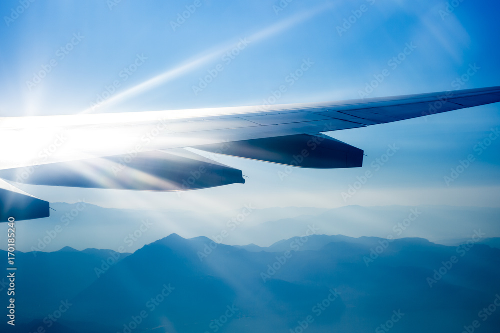 Wing aircraft against the sky in the sunlight
