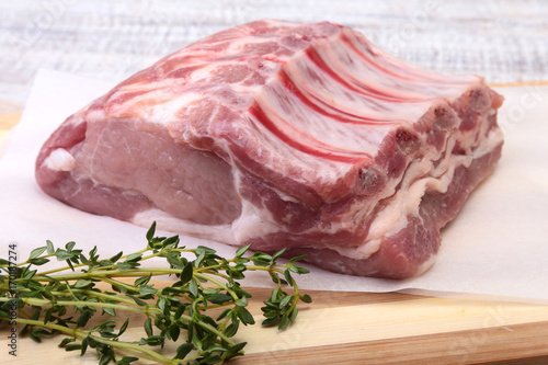 Raw pork chops, spices and rosemary on cutting board. Ready for cooking.