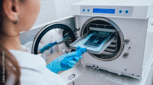 Sterilizing medical instruments in autoclave photo