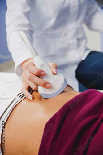 female doctor operating ultrasound scanner photo